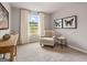 Bedroom featuring neutral walls, a chair, side table, and bright natural light at 5615 Hislop Ln # 82, Mableton, GA 30126