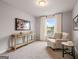 Bright bedroom with a window, side table, chair, and stylish decor at 5615 Hislop Ln # 82, Mableton, GA 30126