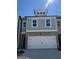 Charming two-story home showcasing a brick and siding exterior with a spacious two-car garage at 5615 Hislop Ln # 82, Mableton, GA 30126