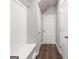 Hallway featuring built-in bench with storage and multiple doors at 5615 Hislop Ln # 82, Mableton, GA 30126