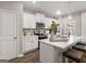 Well-lit kitchen with stainless appliances, white cabinets, quartz countertops, and an island at 5615 Hislop Ln # 82, Mableton, GA 30126