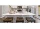 Modern kitchen featuring a large island with seating, stainless steel appliances, and sleek white cabinetry at 5615 Hislop Ln # 82, Mableton, GA 30126