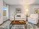 Bright living room featuring a cozy seating area with white sofa and eye-catching butterfly artwork at 5615 Hislop Ln # 82, Mableton, GA 30126