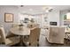 Open-concept living space with a dining area, fireplace, and white upholstered furniture at 5615 Hislop Ln # 82, Mableton, GA 30126
