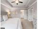 Bright main bedroom featuring a tray ceiling, ceiling fan, and ensuite bathroom at 5615 Hislop Ln # 82, Mableton, GA 30126