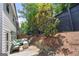 Cozy backyard featuring a stone retaining wall and outdoor seating area with furniture at 774 Belrose Dr, Smyrna, GA 30080