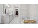 Well-lit bathroom with double sinks, soaking tub, and walk-in closet access at 774 Belrose Dr, Smyrna, GA 30080