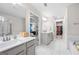 Luxury bathroom with double vanities, tiled floors, and separate shower and bathtub at 774 Belrose Dr, Smyrna, GA 30080