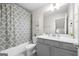 Neutral bathroom featuring a gray vanity with white countertop and a shower with patterned curtain at 774 Belrose Dr, Smyrna, GA 30080