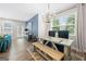 Dining area with modern lighting, large windows and beautiful decor; open concept with living area at 774 Belrose Dr, Smyrna, GA 30080