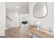 Bright entryway featuring a modern console table, decorative mirror, and hardwood floors at 774 Belrose Dr, Smyrna, GA 30080