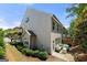 Back exterior featuring a patio seating area, small lawn, and landscaped bushes on the perimeter at 774 Belrose Dr, Smyrna, GA 30080