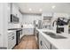 Modern kitchen features stainless steel appliances, updated finishes, and a view of the open living space at 774 Belrose Dr, Smyrna, GA 30080