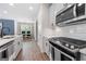 Modern kitchen with stainless steel appliances, a sleek island, and open access to the dining area at 774 Belrose Dr, Smyrna, GA 30080