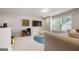 Bonus room with a gray sofa, tv, wet bar with a rainbow colored rug, and a beanbag chair at 774 Belrose Dr, Smyrna, GA 30080