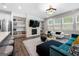 Open-concept living room with modern fireplace, built-in shelves, and lots of windows for natural light at 774 Belrose Dr, Smyrna, GA 30080