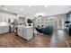 Open-concept living area with a kitchen island, fireplace, and comfortable seating at 774 Belrose Dr, Smyrna, GA 30080