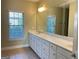 Bathroom with double vanity, white cabinets, and large mirror, offering plenty of counter space at 120 Chastain # 1803, Kennesaw, GA 30144