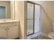 Bathroom featuring a vanity, mirror, toilet, and a glass-enclosed shower at 120 Chastain # 1803, Kennesaw, GA 30144
