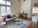 Bright living room with high ceilings, hardwood floors, and a large window that floods the space with natural light at 120 Chastain # 1803, Kennesaw, GA 30144