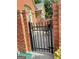 Enclosed brick patio with slate flooring and wrought iron gate and a view of the surrounding landscape at 120 Chastain # 1803, Kennesaw, GA 30144