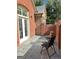 Enclosed patio with slate flooring and a wrought iron chair and table set at 120 Chastain # 1803, Kennesaw, GA 30144