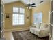 Cozy sunroom with vaulted ceilings, large windows, and a comfortable loveseat at 120 Chastain # 1803, Kennesaw, GA 30144