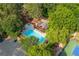 Aerial view of a community pool, clubhouse, parking, and tennis court surrounded by trees at 210 Hunters Vw, Roswell, GA 30075