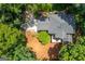 Overhead view of the home showing roof, deck and surrounding land and foliage at 210 Hunters Vw, Roswell, GA 30075