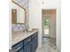 Bathroom with blue vanity, light countertop, modern geometric wallpaper and herringbone pattern floors at 210 Hunters Vw, Roswell, GA 30075