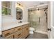 Updated bathroom with a glass shower, light wood cabinets, quartz countertops, and modern fixtures at 210 Hunters Vw, Roswell, GA 30075
