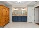 Bathroom featuring a light tile floor, wooden armoire, and granite countertop vanity at 210 Hunters Vw, Roswell, GA 30075