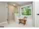 Bright bathroom features a glass shower, soaking tub, and wooded backyard views at 210 Hunters Vw, Roswell, GA 30075