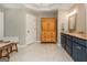 Bathroom featuring a light tile floor, wooden armoire, and granite countertop vanity at 210 Hunters Vw, Roswell, GA 30075