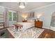 Bright bedroom featuring a decorative rug, bench, and large window for lots of natural light at 210 Hunters Vw, Roswell, GA 30075
