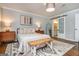 Bright bedroom featuring a decorative rug, bench, and ensuite bath at 210 Hunters Vw, Roswell, GA 30075