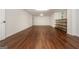 Bonus room featuring hardwood floors, a window, a white door, and neutral walls at 210 Hunters Vw, Roswell, GA 30075