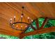 Rustic outdoor ceiling with wooden beams and a wrought iron chandelier at 210 Hunters Vw, Roswell, GA 30075