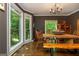 Inviting dining room with large windows, a rustic wooden table, and bench seating at 210 Hunters Vw, Roswell, GA 30075
