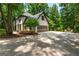 Exterior view of the stucco home with a large parking area and a two-car garage at 210 Hunters Vw, Roswell, GA 30075