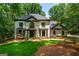 Stately two-story home with a manicured lawn and mature trees at 210 Hunters Vw, Roswell, GA 30075