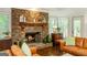 Living room with stone fireplace and built-in cabinetry, hardwood floors, and comfortable seating at 210 Hunters Vw, Roswell, GA 30075