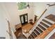Grand foyer featuring dark wood floors, a staircase, a bench and double doors at 210 Hunters Vw, Roswell, GA 30075
