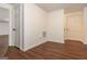 Hallway with hardwood floors and white doors creating a clean and bright transitional space at 210 Hunters Vw, Roswell, GA 30075
