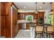 Kitchen featuring wooden cabinets, stainless steel appliances, and a kitchen island with bar stools at 210 Hunters Vw, Roswell, GA 30075