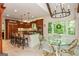 Bright kitchen with granite countertops, wood cabinetry, stainless appliances, and casual dining area at 210 Hunters Vw, Roswell, GA 30075