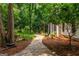 Stone pathway leading through lush landscaping to the side of the home, creating a serene outdoor space at 210 Hunters Vw, Roswell, GA 30075