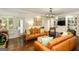 Spacious living room with hardwood floors, built-in shelves, and access to the outdoors at 210 Hunters Vw, Roswell, GA 30075