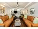 Bright living room features hardwood floors, leather sofas, custom built-ins, and modern lighting at 210 Hunters Vw, Roswell, GA 30075
