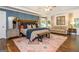 Spacious main bedroom with a large rug, wooden accents, and a seating area at 210 Hunters Vw, Roswell, GA 30075